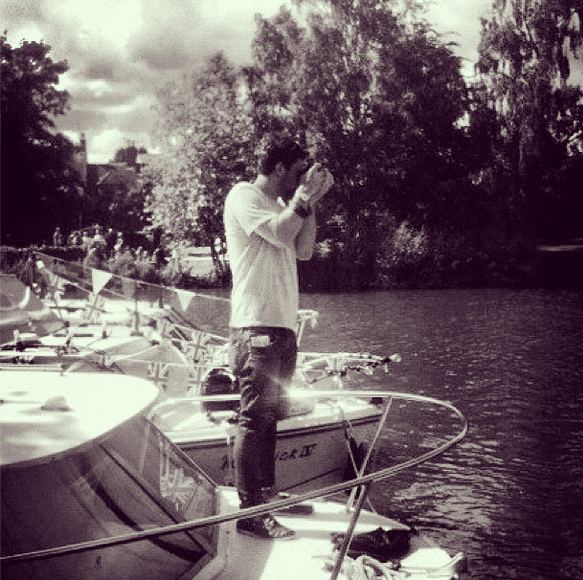 male on boat taking photos