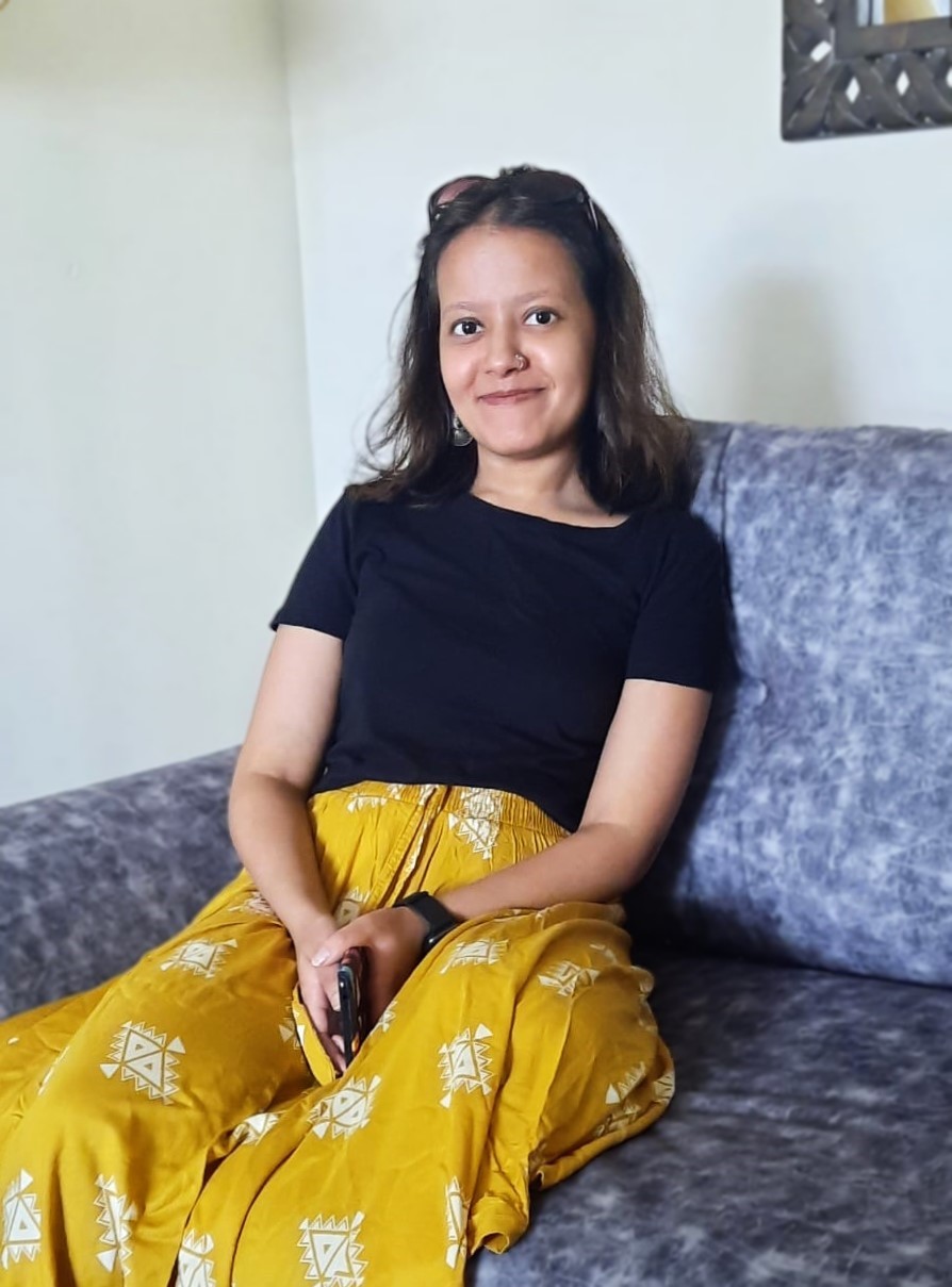 Akanksha sitting on sea smiling